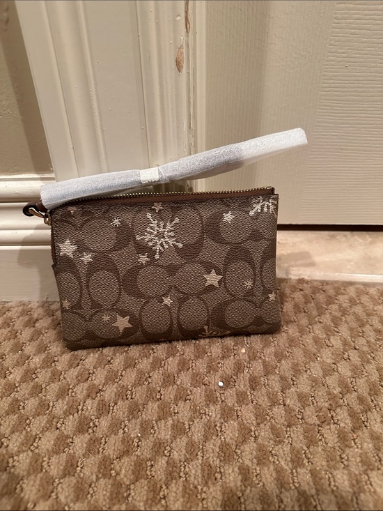 Coach Handbags - Coach Brown Signature Canvas Wristlet with Silver Star and Snowflake Accents